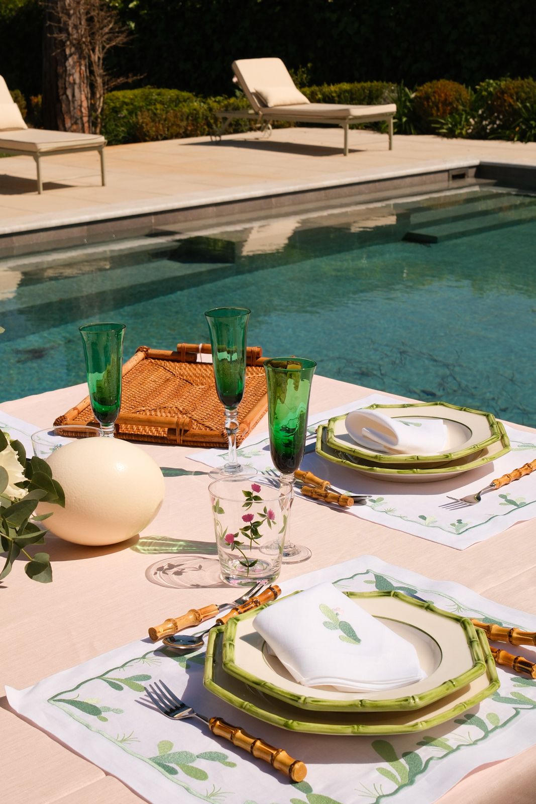 Table dressed with hand-embroidered Maison Alia linen placemats and napkins