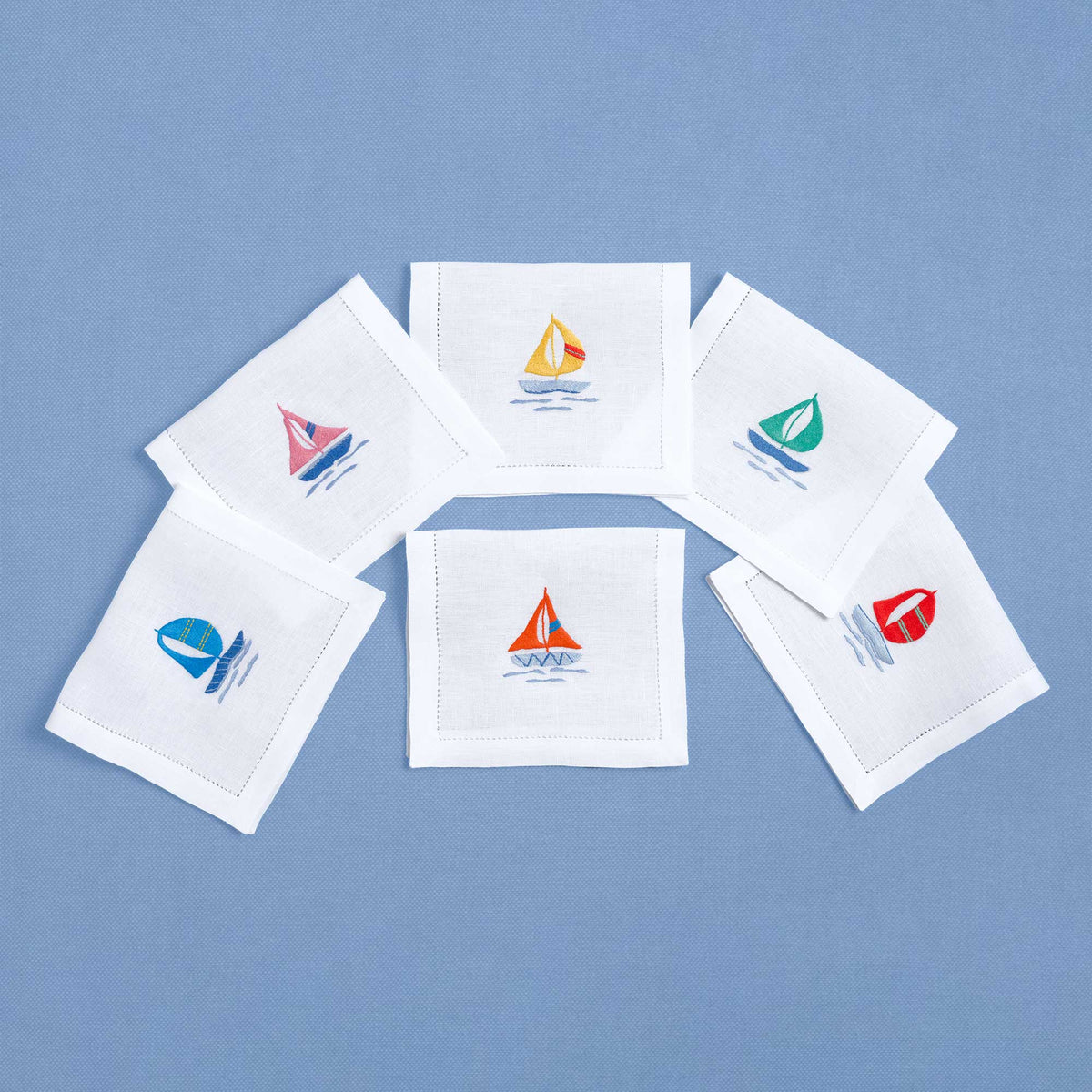 Colored Sailboats embroidered sailboat detail on white linen