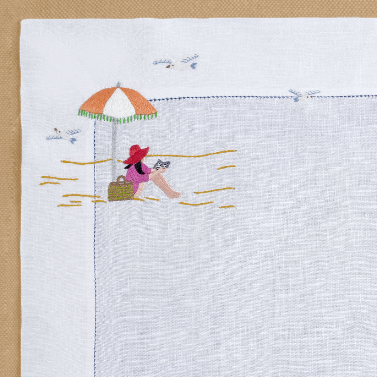 Close-up of Deauville embroidery on white linen