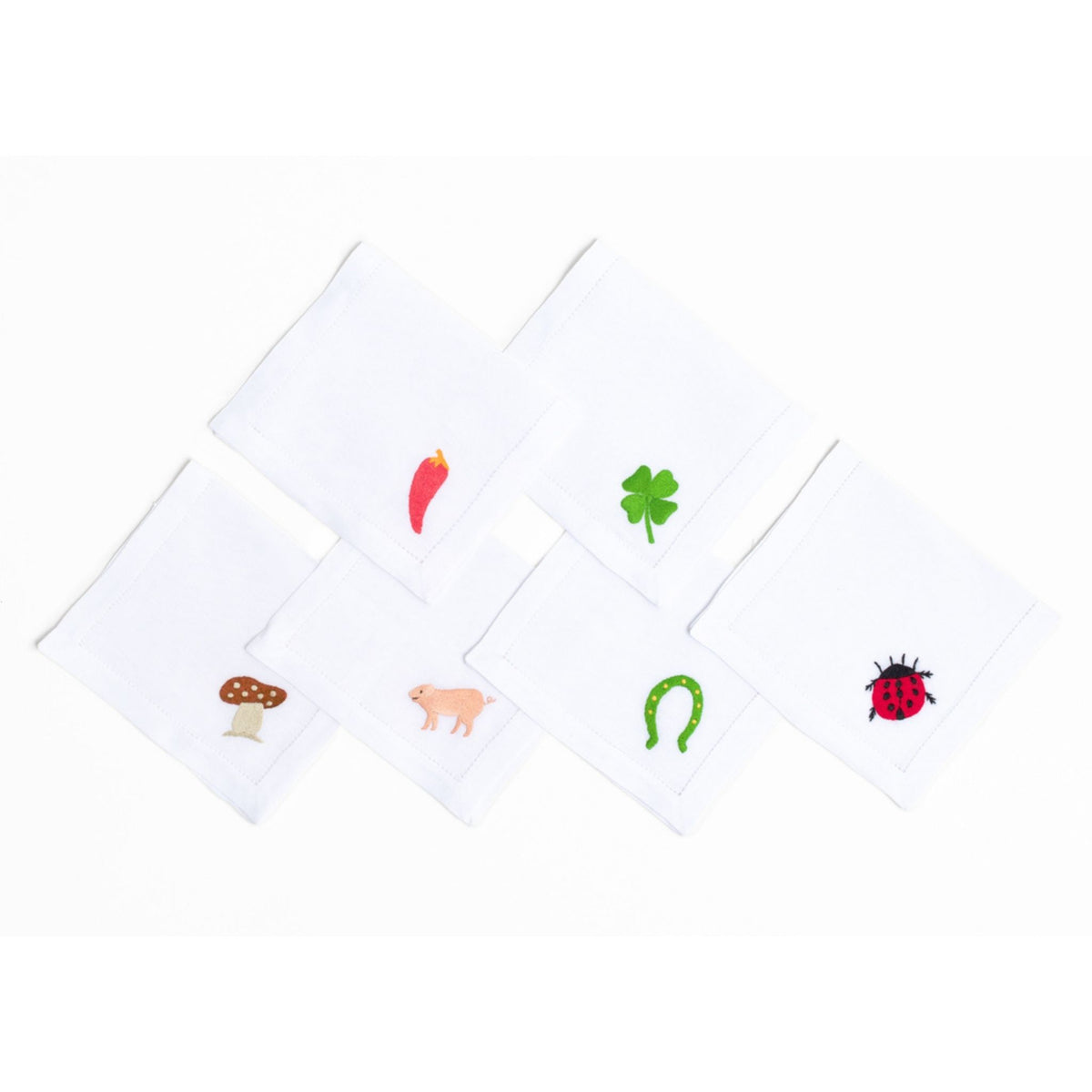 Lucky Charms embroidered charm detail on white linen cocktail napkin