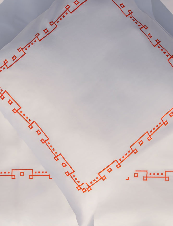Maison Alia Geometria Arancione luxury bed set - orange diamond geometric hand-embroidery on premium white linen