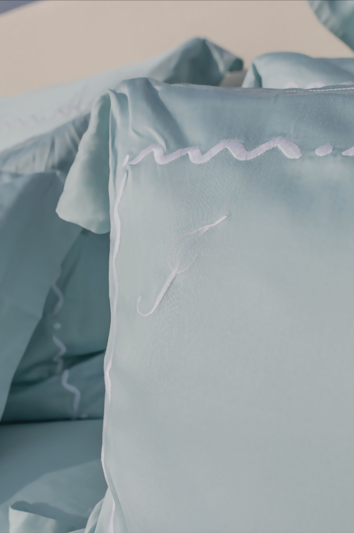 Oceano Turchese luxury bed set by Maison Alia - light blue linen fabric with custom embroidery
