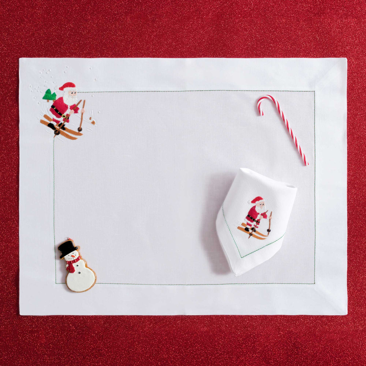 Close-up of embroidered skiing Father Christmas on white linen