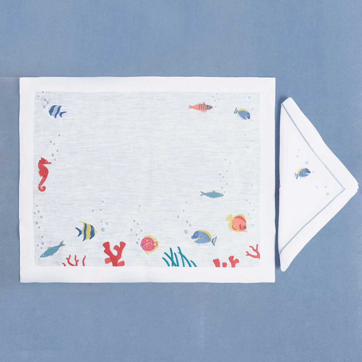 Poissons Exotiques embroidered exotic fish linen placemat and napkin set — Maison Alia
