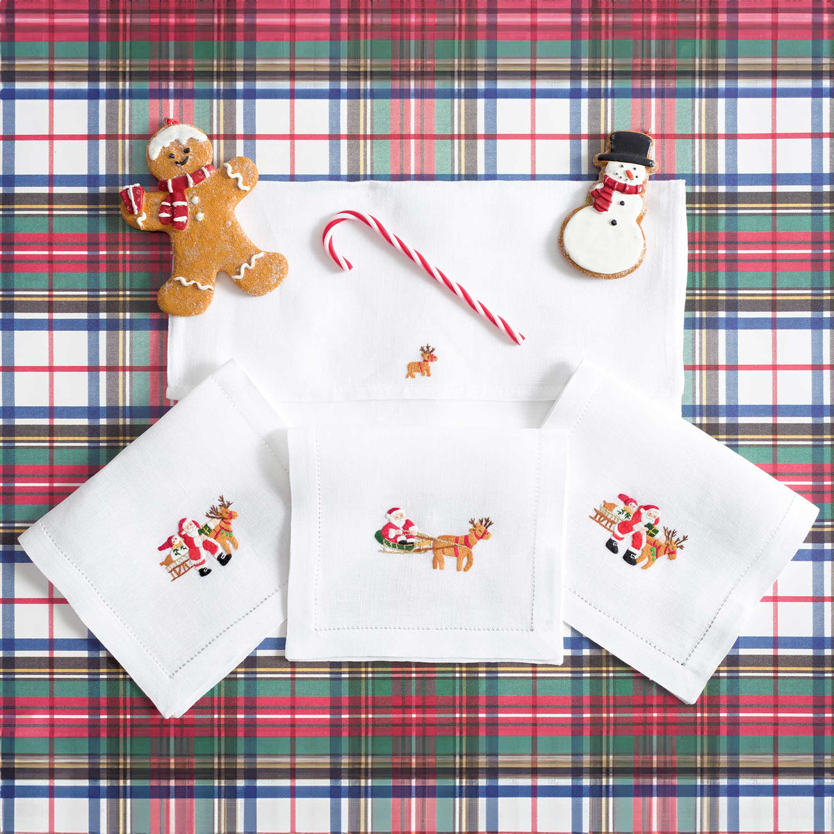 Close-up of embroidered Father Christmas on white linen cocktail napkin