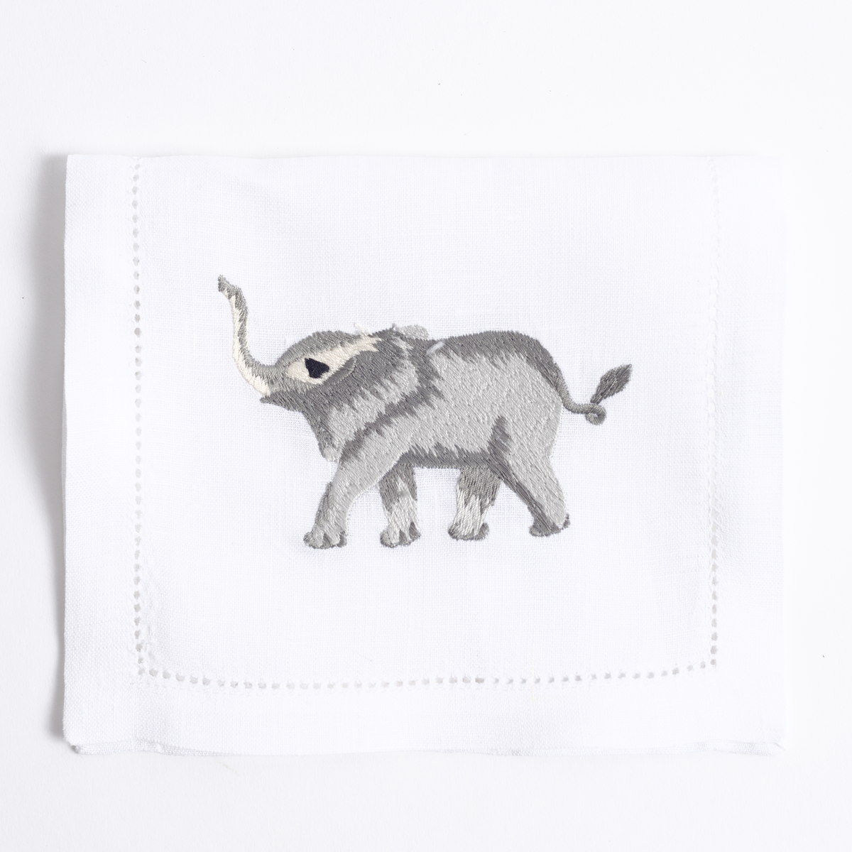 Savanna embroidered animal motif on white linen cocktail napkin