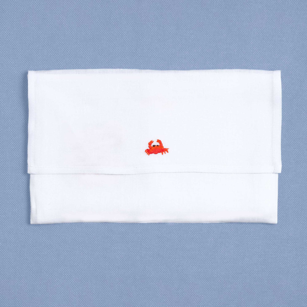 Shellfish embroidered shell detail on white linen cocktail napkin