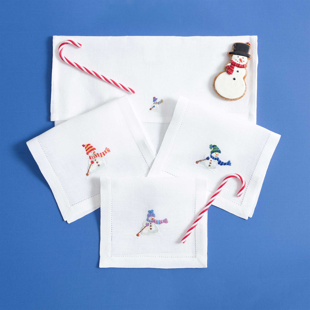 Snowmen embroidered festive motif on white linen cocktail napkin