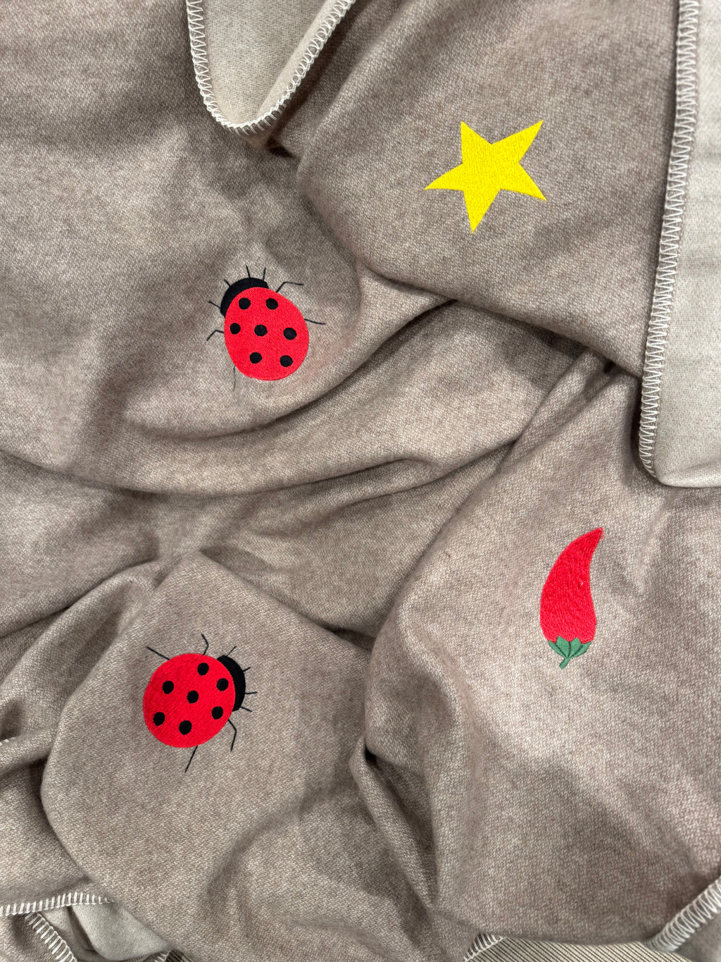 Two-tone cashmere throw folded detail — Maison Alia
