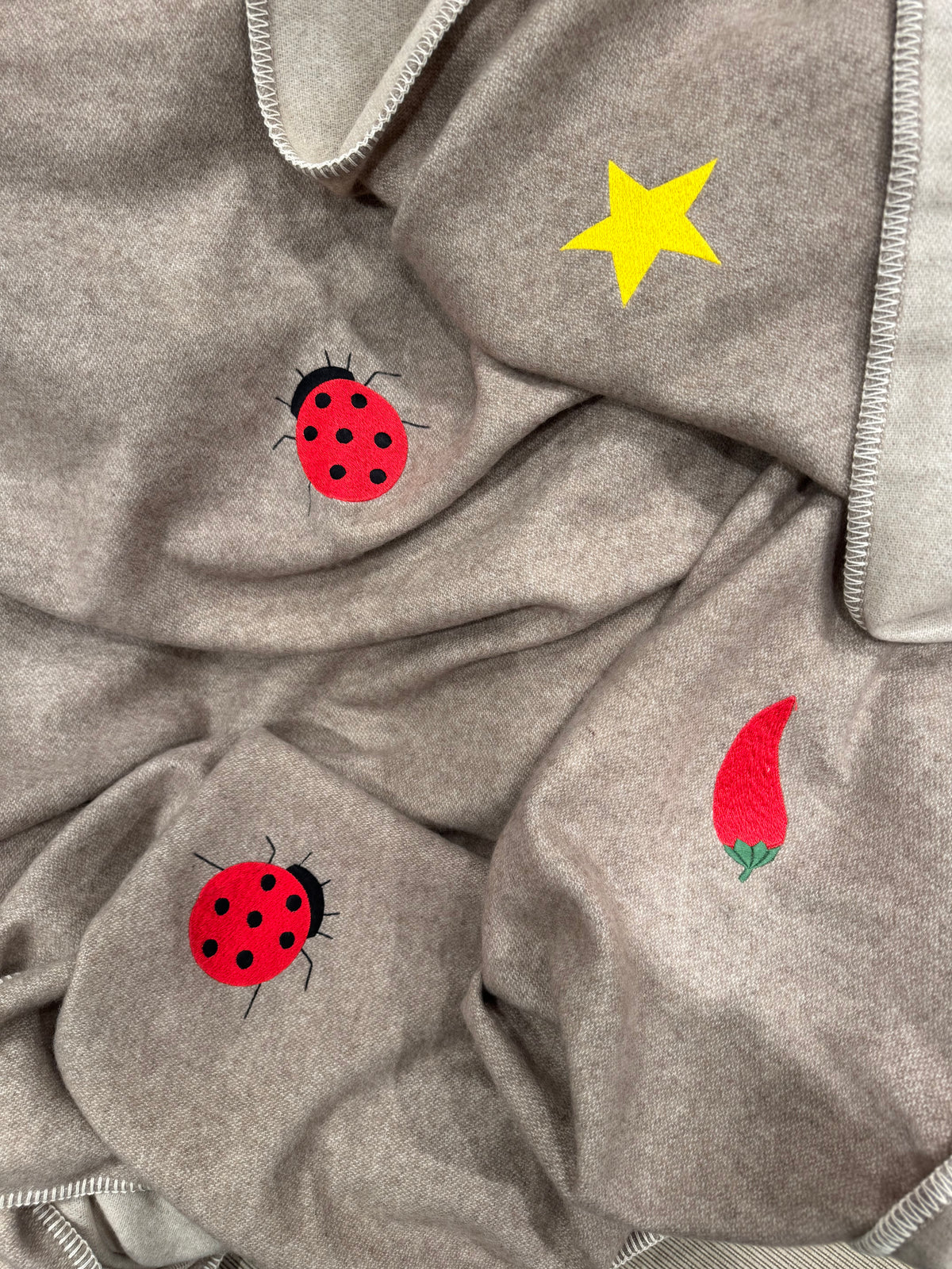 Two-tone cashmere throw folded detail — Maison Alia
