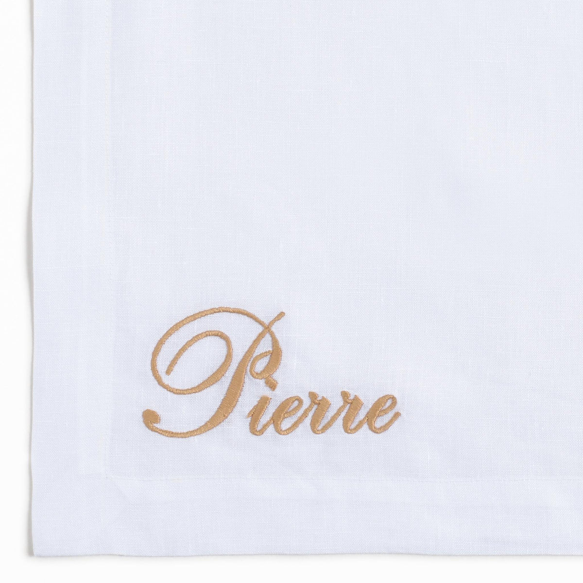 Close-up of embroidered giraffes on white linen — Maison Alia
