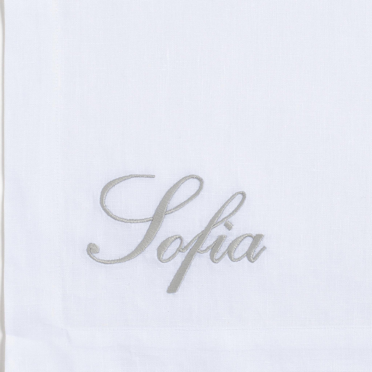 Close-up of embroidered zebra on white linen — Maison Alia